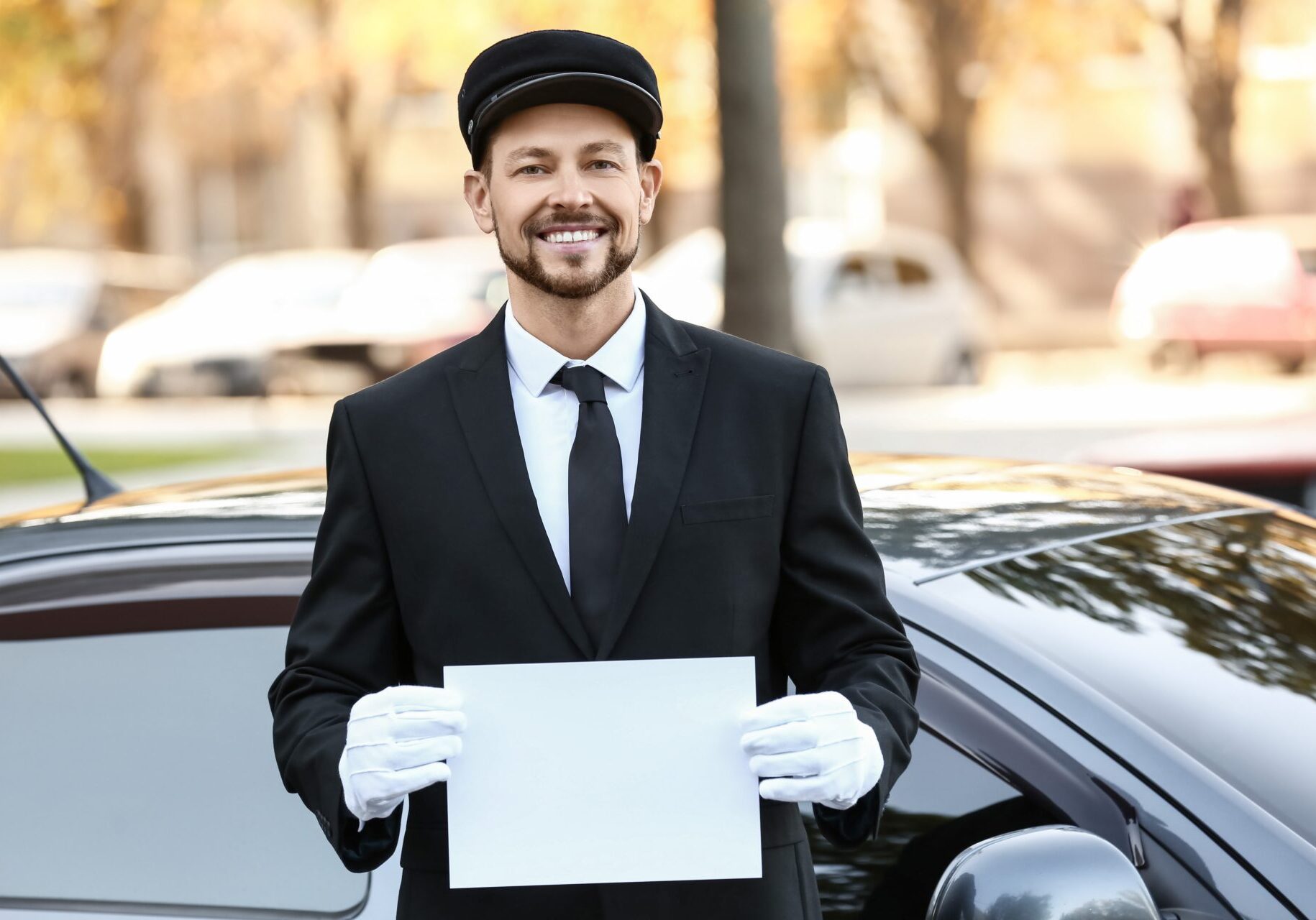 Handsome,Chauffeur,With,Blank,Paper,Sheet,Near,Luxury,Car